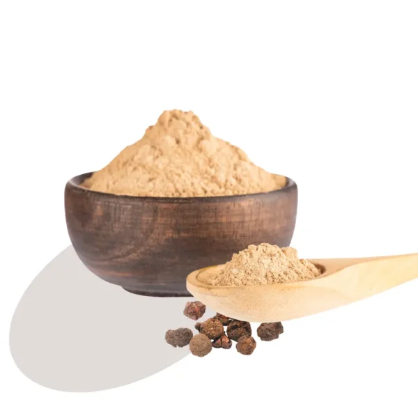 A wooden bowl filled with amla powder, with a wooden spoon lying alongside the bowl.